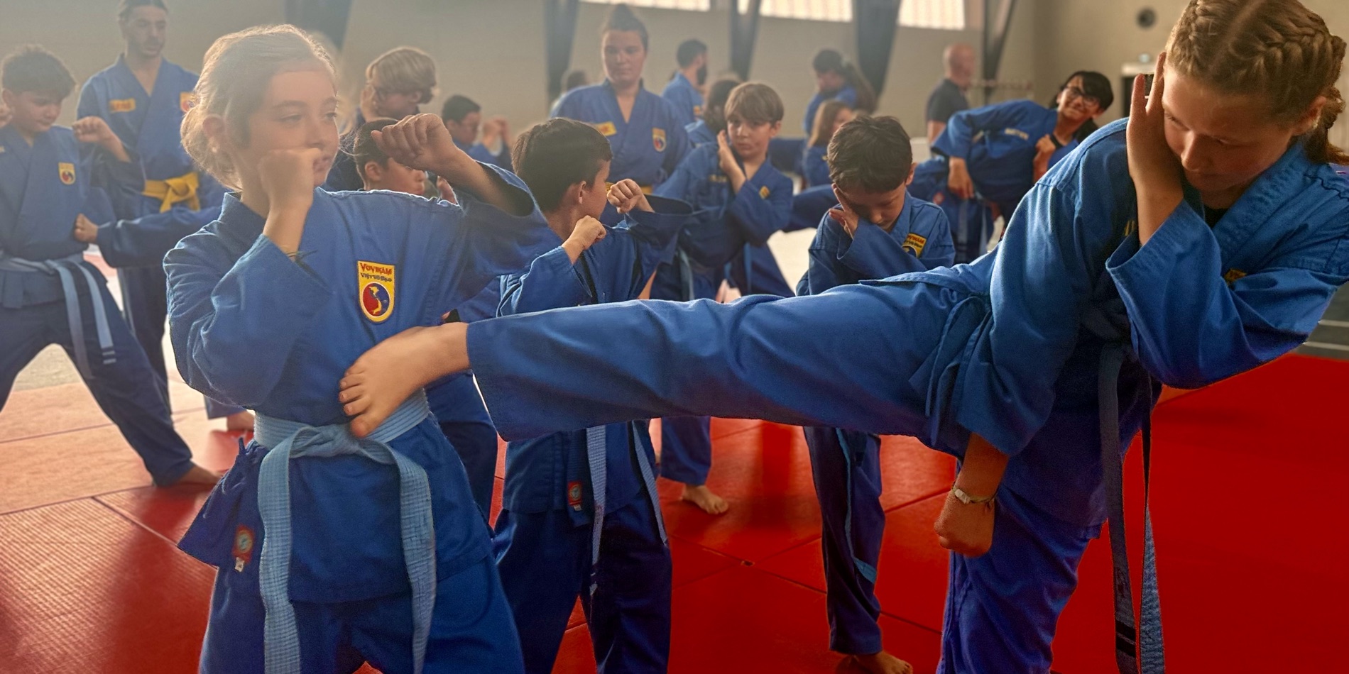 Jeunes pratiquants de Vovinam en plein coup de pied